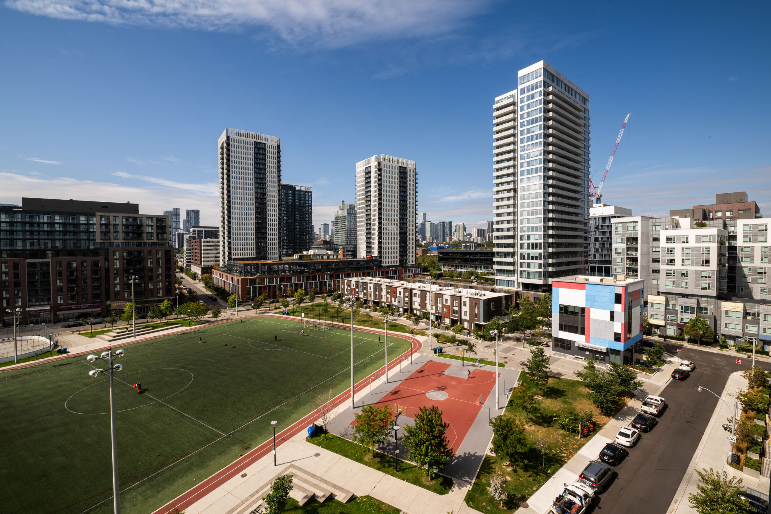 Render of Evolv. Kids playing soccer in the foreground